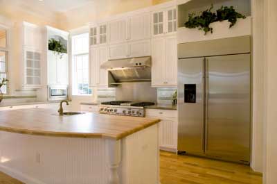 The use of stainless steel kitchen appliances provides a crisp clean functional look to the work areas.