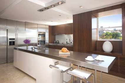 Modern stainless steel kitchen - Positive work triangle at the far end leaving the closer end free for casual dining or perhaps working.