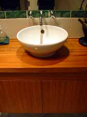 Bathroom planning - A porcelain vessel inserted into a rimu timber vanity unit.