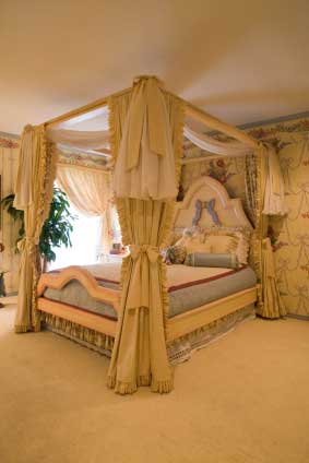 Four poster bed with elaborate curtains