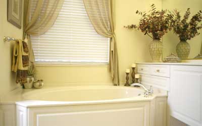 Simple Sheers tied back soften the look of the bathroom. 