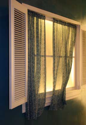 Shutters and casement curtains on curtain wire.