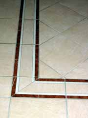 Tiles - Ceramic floor tiles with detailed border design.