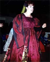 The red gown worn for a medievil party suggests a confident personality. 