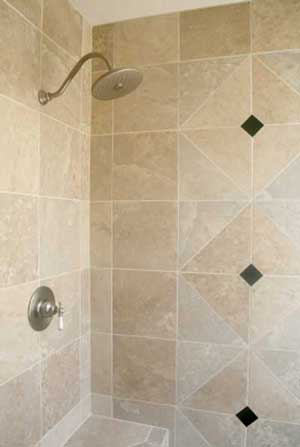 Tiled shower cubicle with traditional shower head.